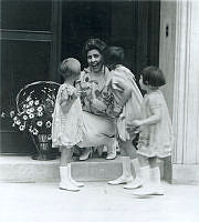 Mrs. Coolidge Gets Flowers and a Kiss from Children