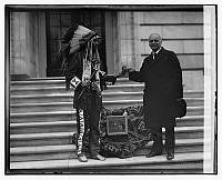 Vice President Curtis Shares a Skookum Apple with a Native American Man